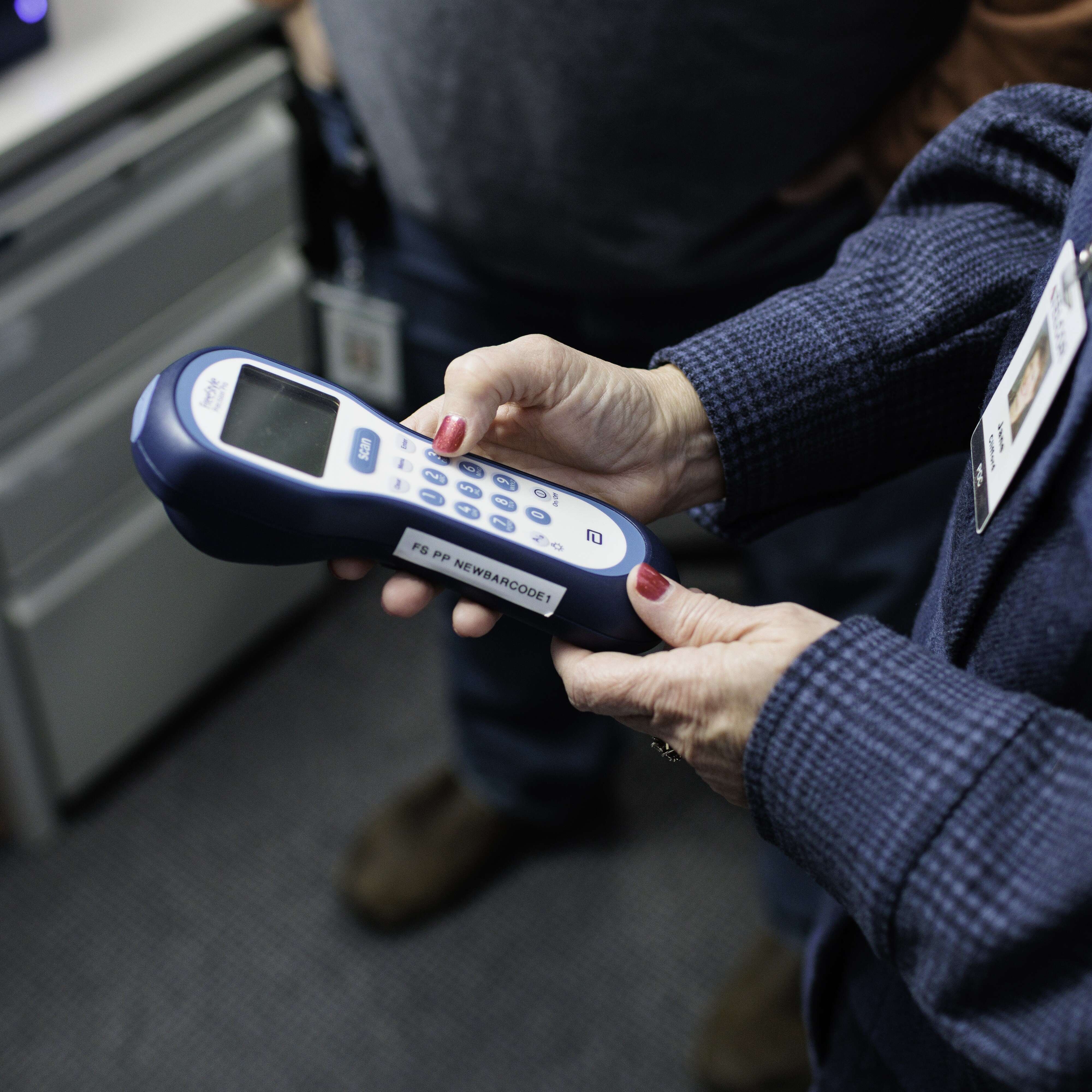 Hands holding a hospital point of care device