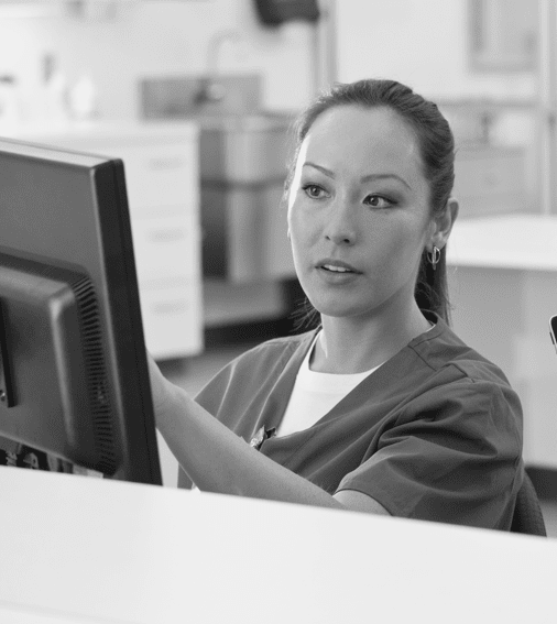 medical worker looking at computer monitor