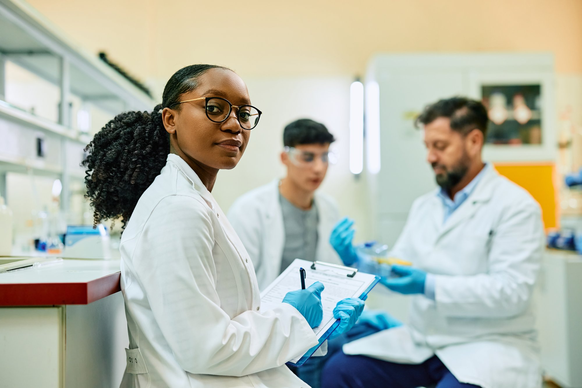 black-female-scientist-writing-notes-during-a-rese-2024-12-13-17-48-24-utc