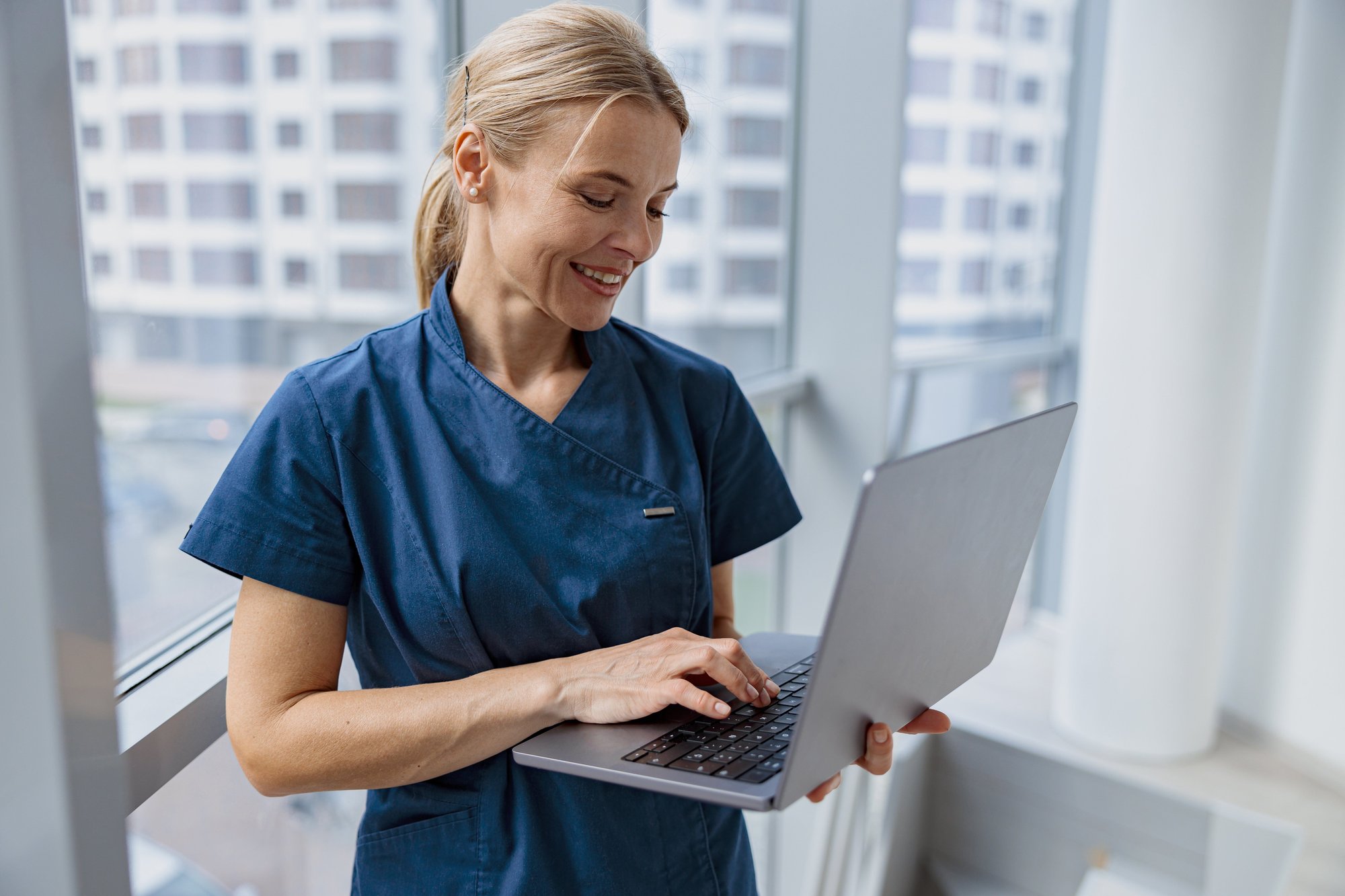 female-healthcare-worker-using-laptop-while-workin-2023-11-27-05-26-45-utc