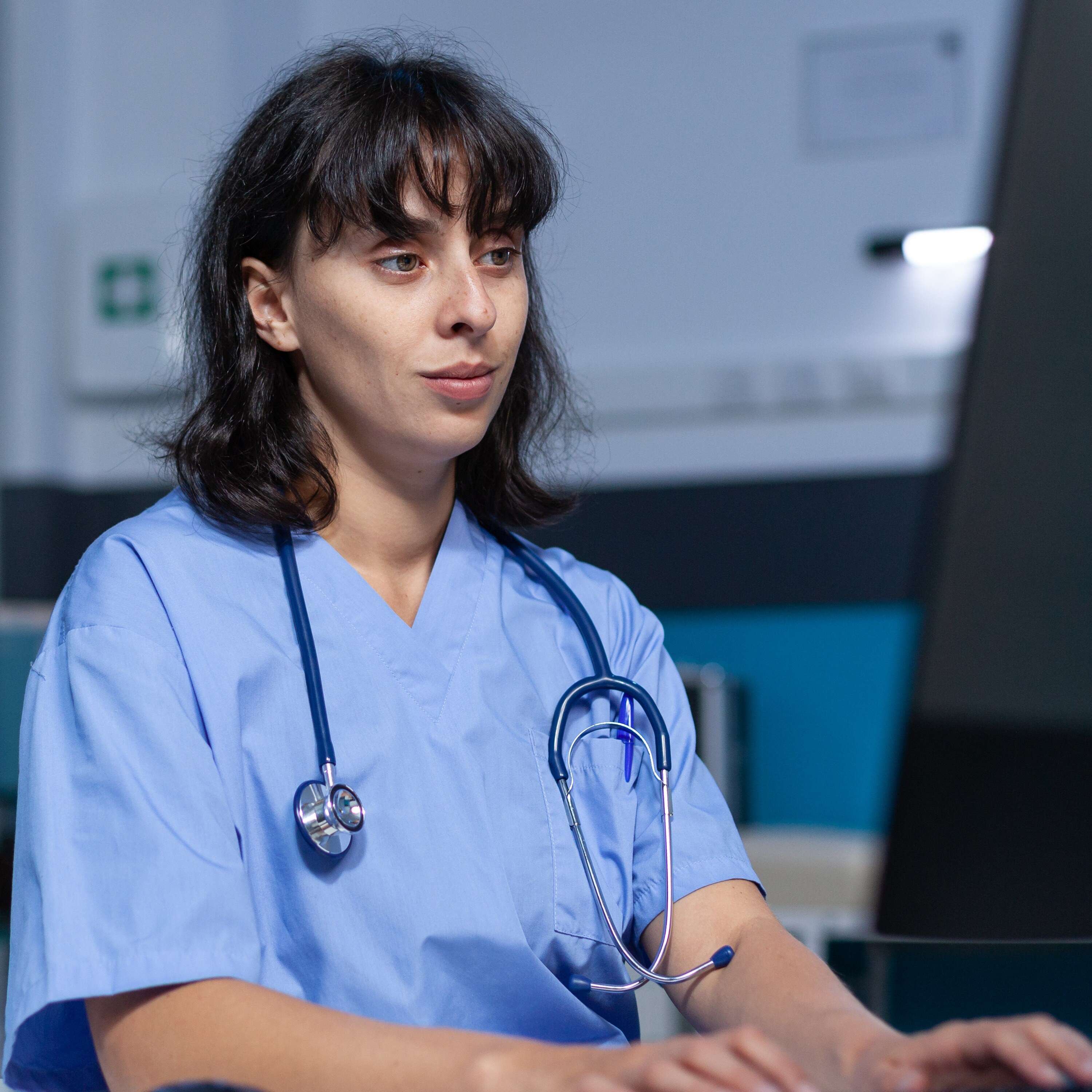 healthcare worker looking at computer monitor