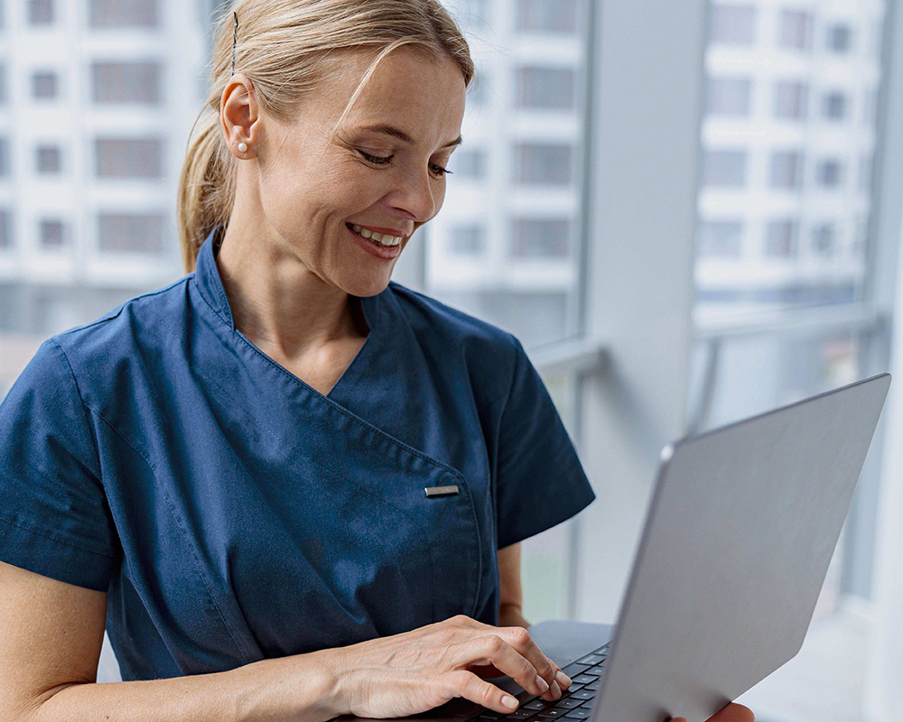 female-healthcare-worker-using-laptop-while-workin-2023-11-27-05-26-45-utc